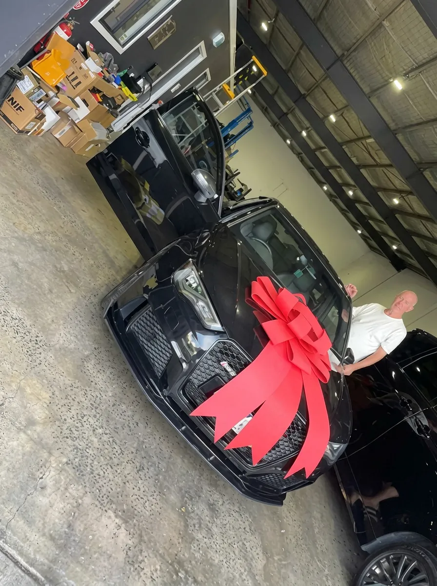 New car delivery with bow financed by JLP Financial